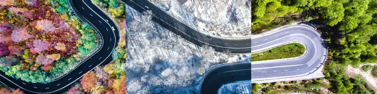 Luftaufnahme einer kurvigen Straße, die durch eine Waldlandschaft im Herbst, Winter und Sommer führt